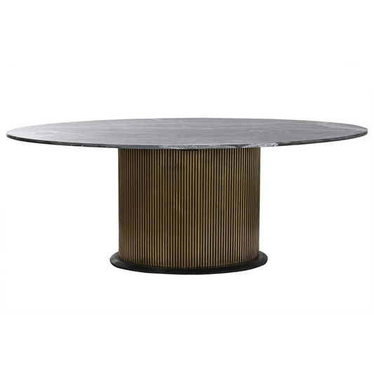 Esta impresionante mesa de comedor combina la belleza natural del mármol negro con la sofisticación del latón dorado, creando una pieza central de lujo y estilo para tu hogar. Su diseño circular promueve la conversación y la interacción entre los comensales, mientras que su base cilíndrica de latón acanalado aporta un toque de elegancia y textura. El tablero de mármol negro, con sus vetas únicas, añade un toque de distinción y personalidad. Con unas dimensiones generosas de 200 cm de diámetro y 76 cm de alt